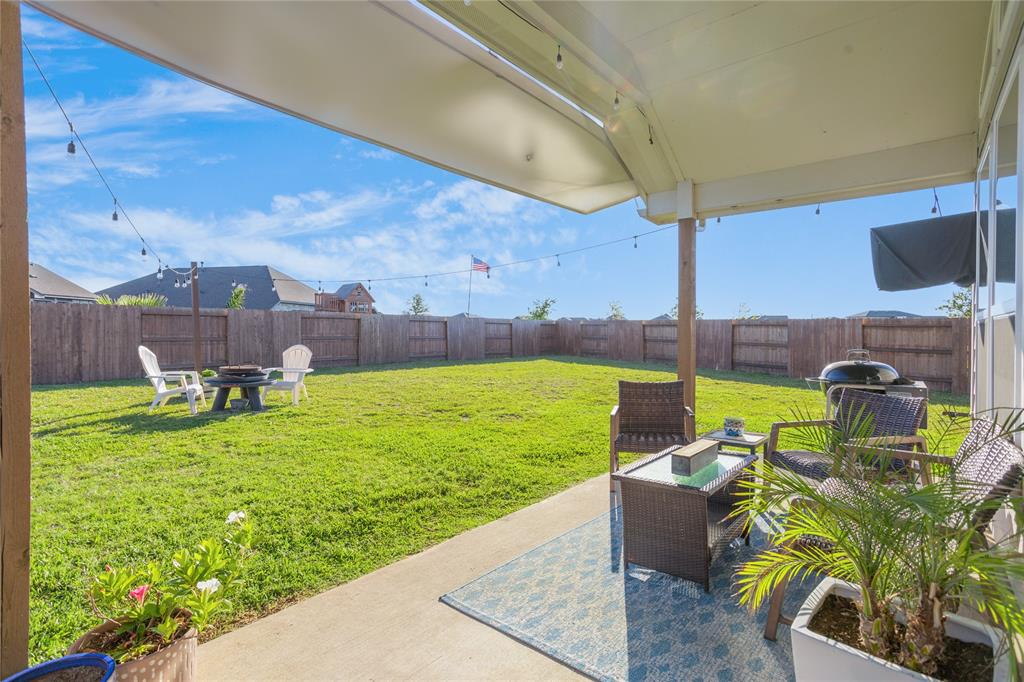 Back patio overlooks mammoth yard