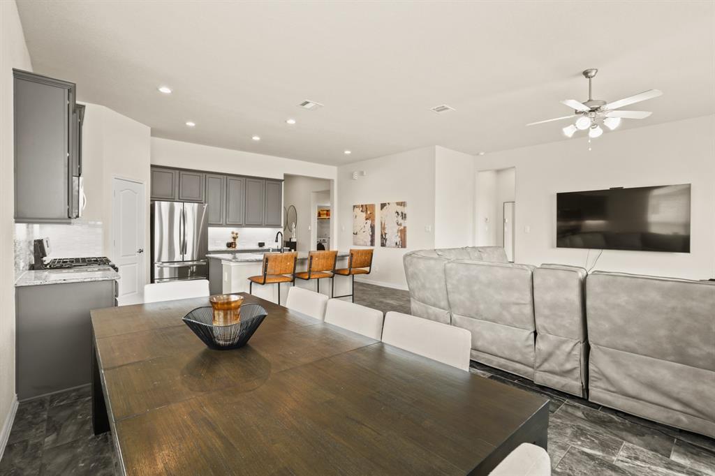 Savor the perfect harmony of morning tranquility and familial warmth in this open breakfast space, seamlessly connected to both the kitchen and family room.