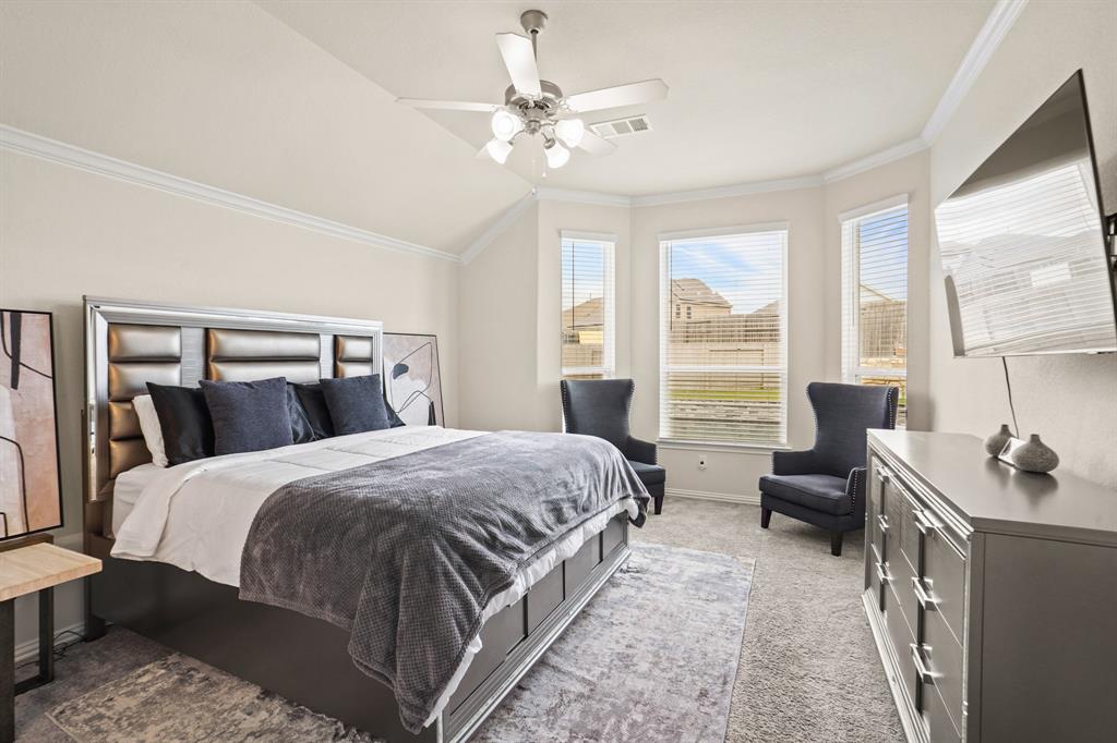 Bask in the serene sanctuary of this Primary Suite, adorned with plush carpet, and elegant bay windows that invite natural light to fill every corner.