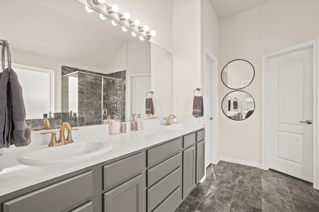 Experience seamless functionality in this primary bathroom, where doors open to reveal a private water closet and a enormous walk-in closet.