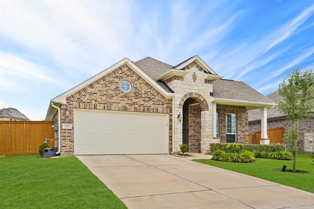 A double-wide driveway leads to the 2-car epoxy-floored garage, complete with dual sconce lighting and an automatic garage door opener, for plenty of convenient parking.