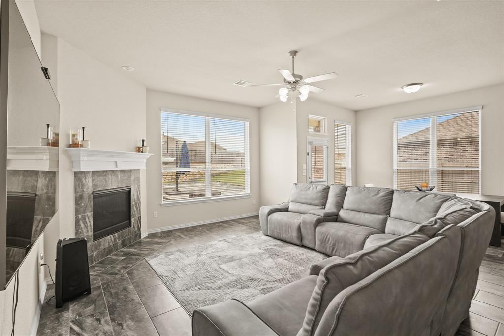 Gather around the warmth and charm of a corner fireplace in this inviting family room, where cherished moments are shared and memories are made.