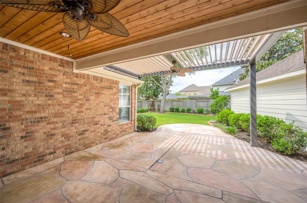 Fabulous outdoor living space with electronic pergola providing sun or shade.