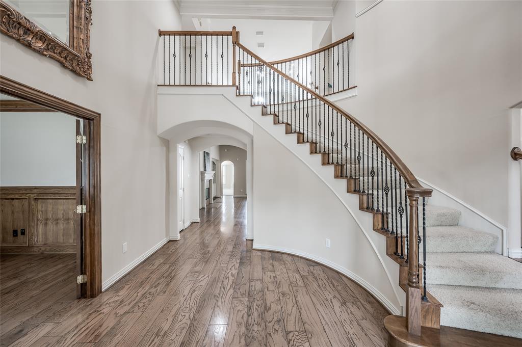 Grand 2-story entrance with sweeping curved staircase sets the stage for this impressive home.