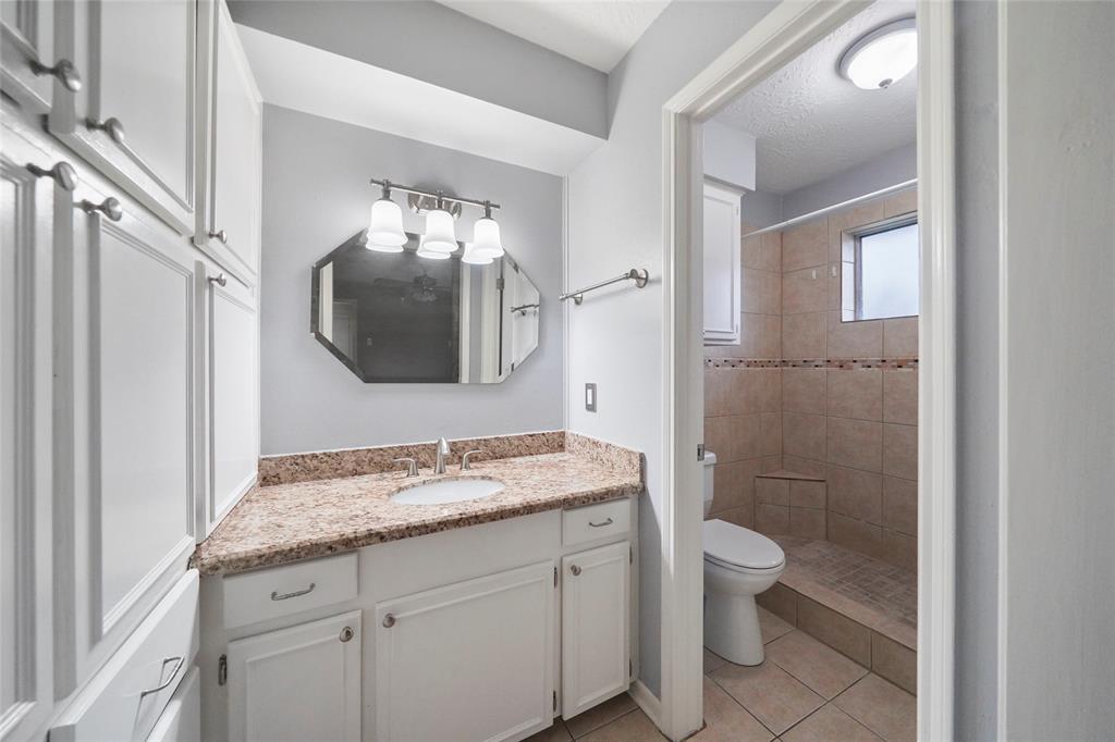 Master bathroom with custom tile shower surround and granite vanity top