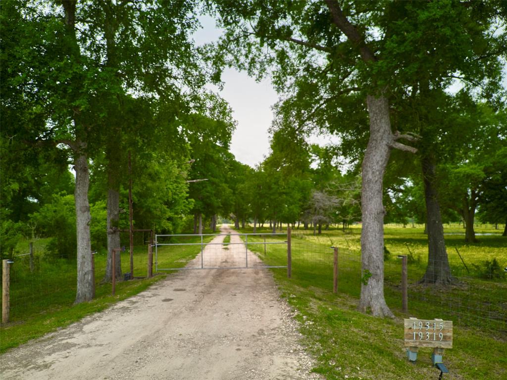 Welcome to fabulous Fort Bend County. This rare and hard to find property offers an unbelievable +/- 117 acres of beautiful land, with totally unrestricted use ability. Located at the edge of Fort Bend County and having a Boling mailing address, this property is still zoned to the highly desired Needville ISD. Enter the private and owned driveway for approximate half mile trip to the great outdoors. This property offers so many options of use that the sky really is the limit. Come see the deer, wild hogs, and numerous other natural habitat. The property already has two very recent manufactured homes that are a good city block between them. The first home was built in 2018 with +/- 2432 sgft. The second was built in 2020 with +/-1640 sgft.  Each home has its own water well, septic system and utilities. Each home is placed lovely with a nice cleared space around each home, yet private from the other. Consider all the potential options this property could offer you now and in the future.