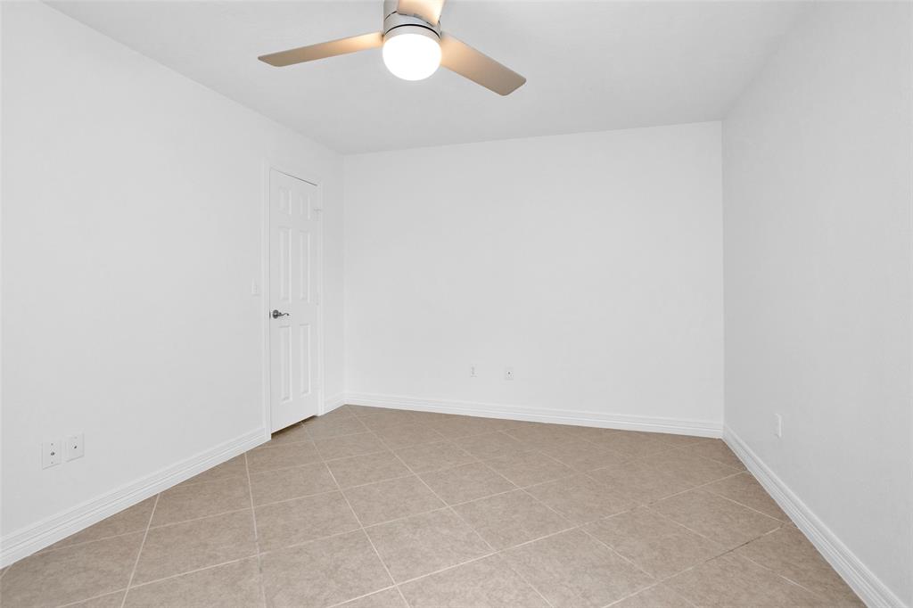 Bedroom #3 is kept cool under an updated ceiling fan & features a nice sized walk-in closet.