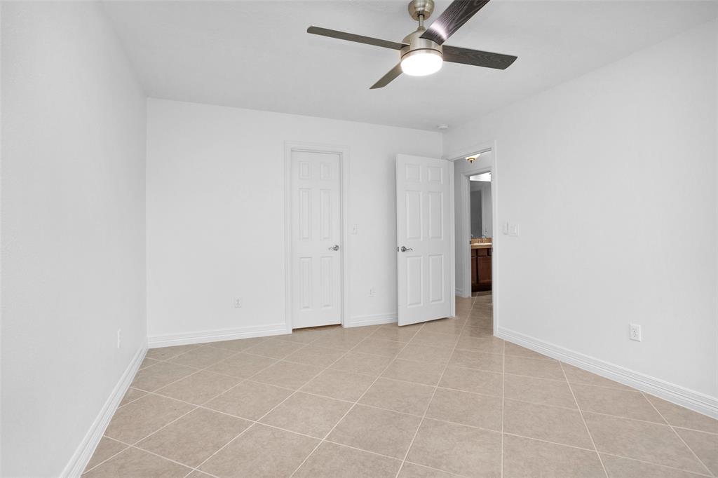 Bedroom #4 w/ an updated ceiling fan is calm & neutral, & offers plenty of closet space.