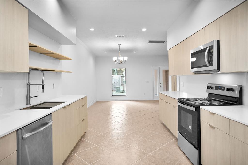 Spacious Kitchen features updated stainless appliances & opens to the Breakfast/Dining Room, and has ample countertop space for meal prepping and entertaining.