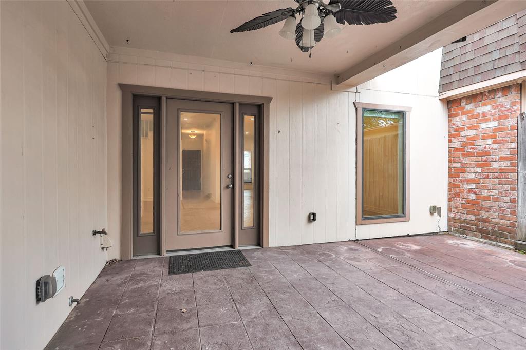 Updated Covered Patio w/ a ceiling fan is steps from the Breakfast Room/Family Room & is perfect for an outdoor Kitchen.