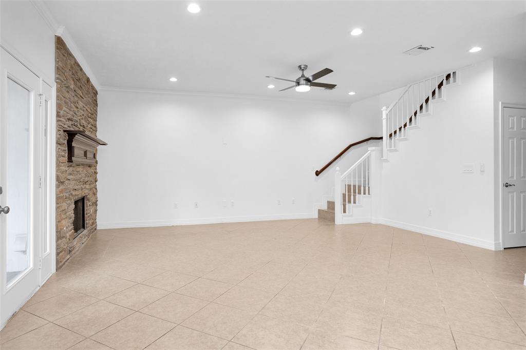 Bright Family Room features updated LED recessed lights, an updated ceiling fan to keep you cool & and brick fireplace which is perfect for cold weather entertaining.