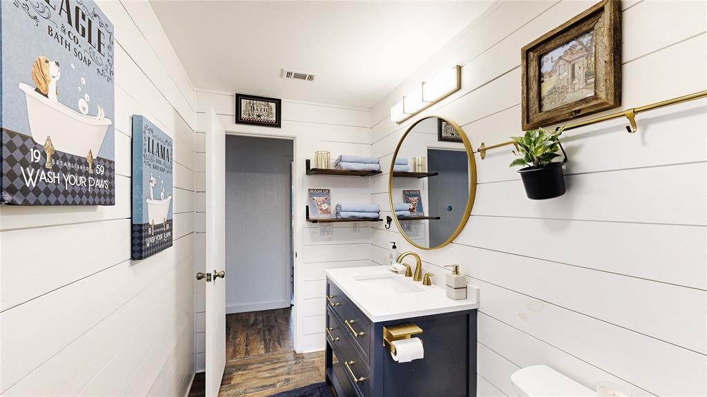 Another view of the 2nd Full Bath. Shiplap accent walls, floating shelves, gold accents, and all new everything!