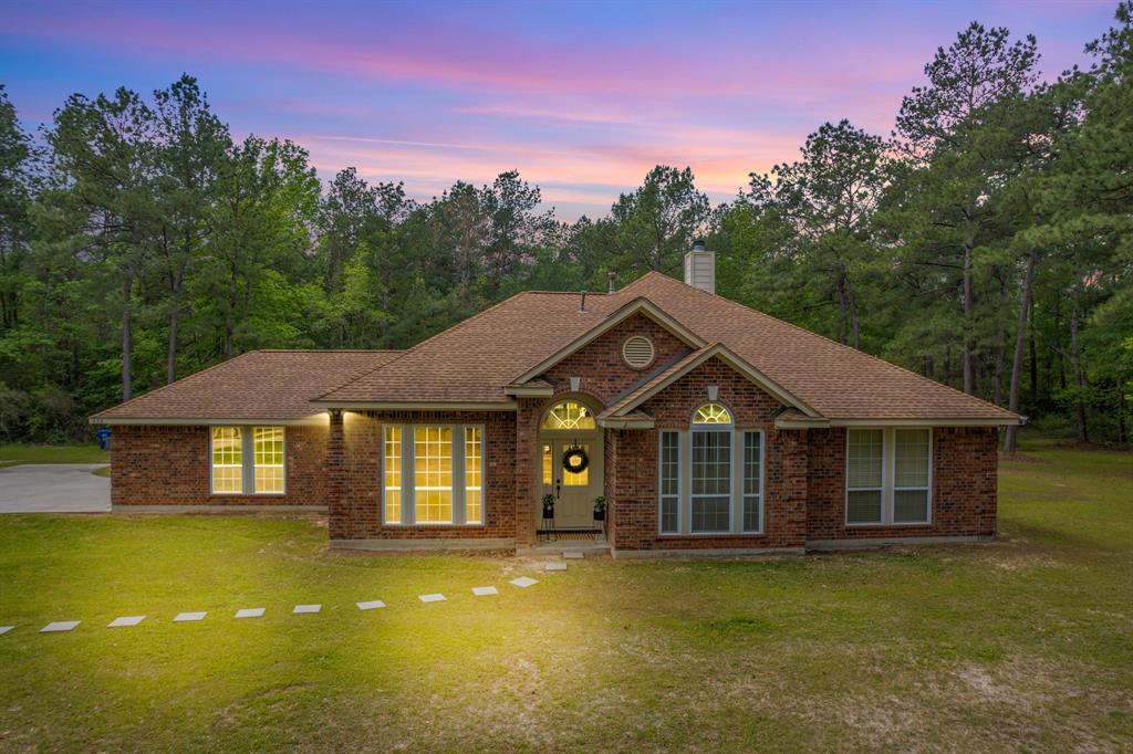 This custom-built home sets on 45 private secluded acres and is surrounded by lush trees and topography. One story home with 4 bedrooms and an extra room off the primary. There is a gorgeous sunroom off back entry that is perfect for enjoying the peace and quiet this property offers. Wood like ceramic tile throughout the living areas, hallways, and kitchen is so durable and easy upkeep. Wood laminate flooring in dining room and all bedrooms, no carpet in this home. Kitchen is open to the living area which is perfect for entertaining. Kitchen has an island and breakfast bar area. Oversized garage with tons of storage space. If you are looking for privacy, this home has it!!