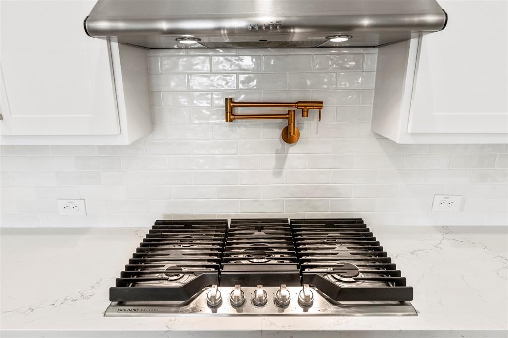 High-end 6 burner gas range and pot filler compliments the space.