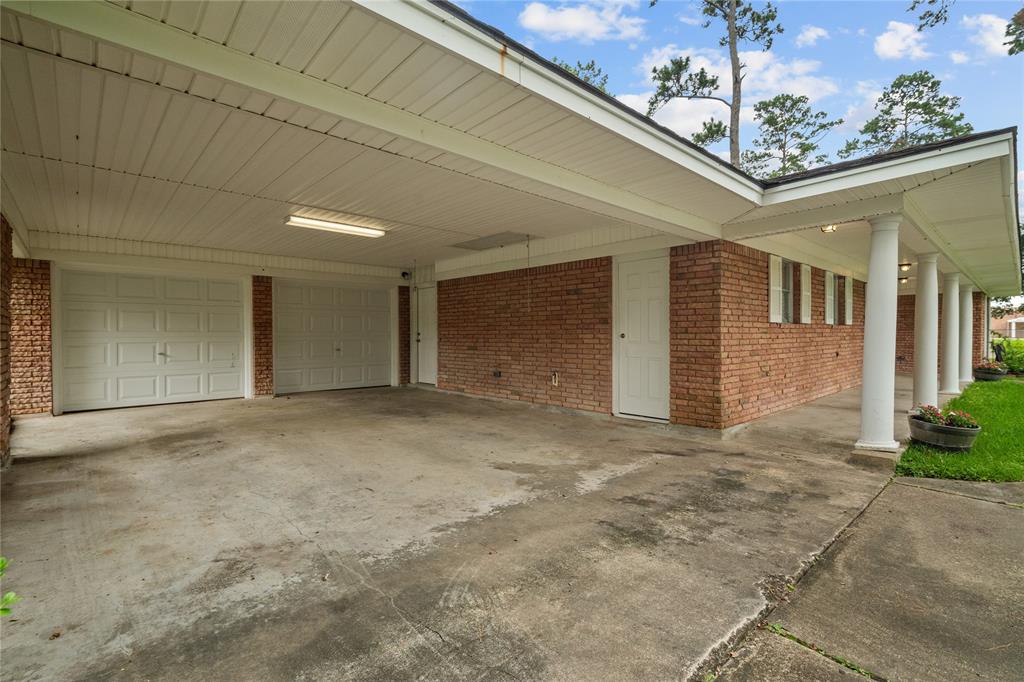 Additional paved covered parking area outside of the double car garage.