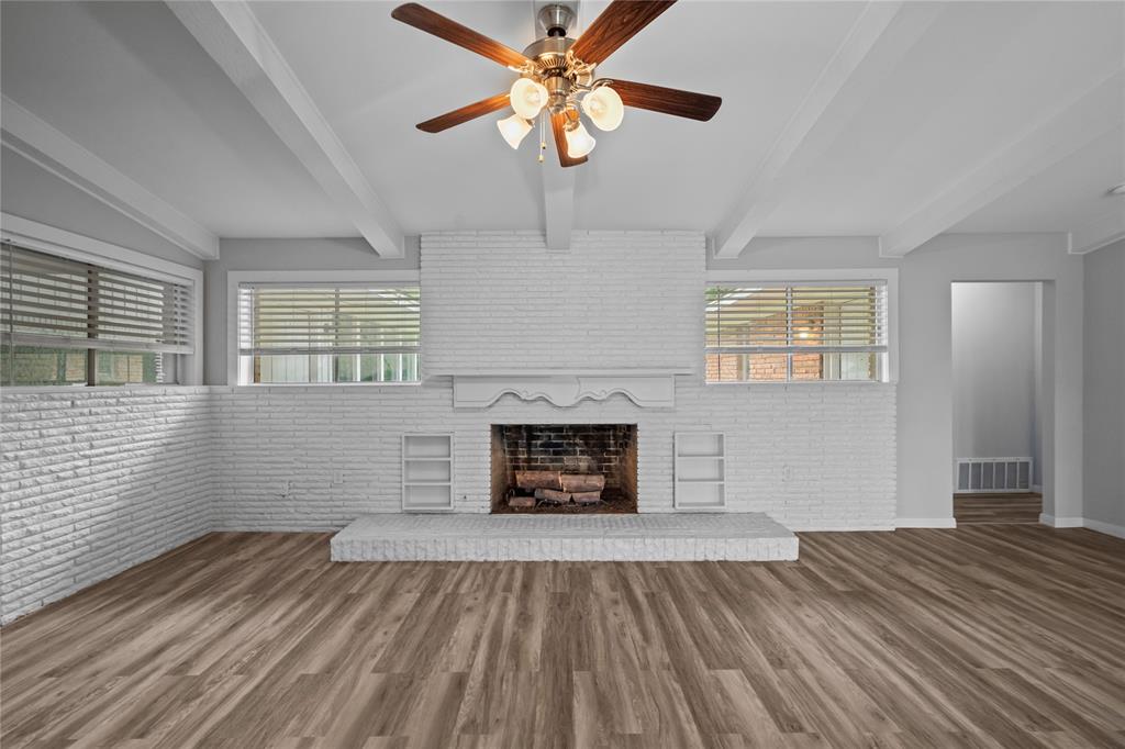 Spacious living room with vaulted ceiling and fireplace.