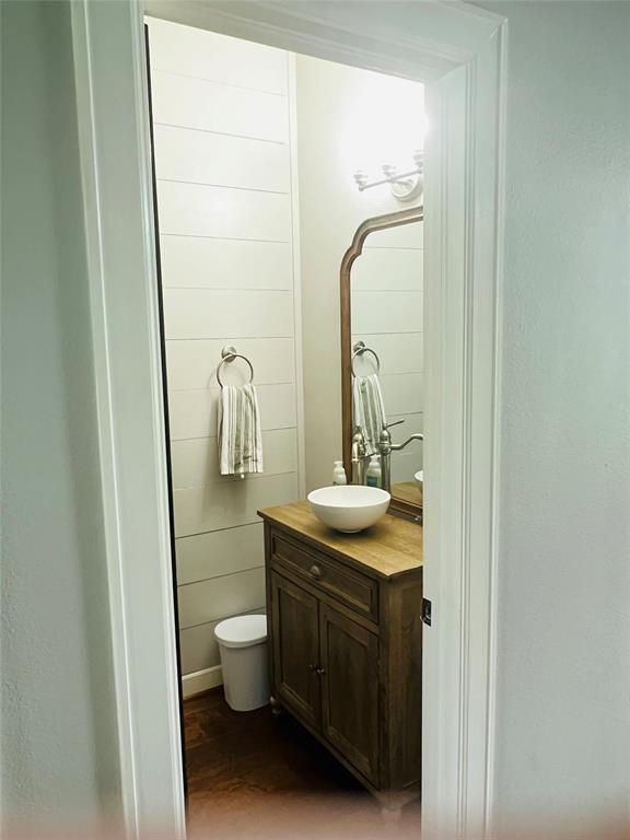 Half bath wood shiplap and custom vanity. Newly painted neutral.