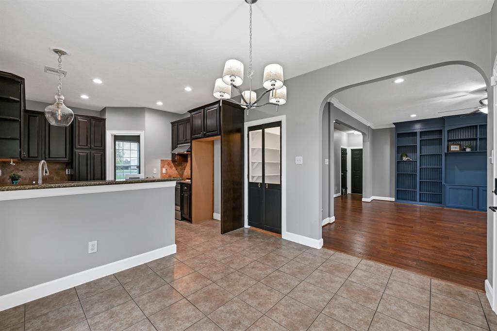 Breakfast room with access to the living area and kitchen. Pantry with custom doors, granite countertops throughout.