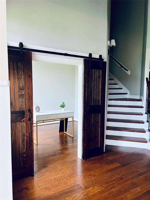 Home office space with barn doors. Newly painted neutral to offer bright and inviting atmosphere.