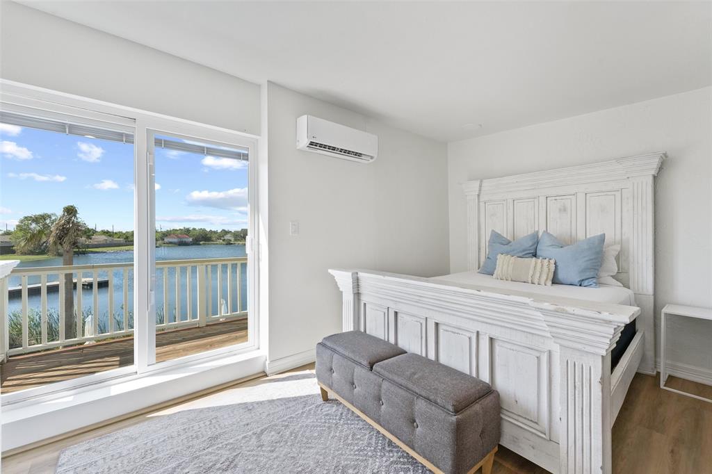 The fifth bedroom upstairs is stunning, with abundant natural light, a balcony for enjoying the coastal breeze, and a view of the lake.