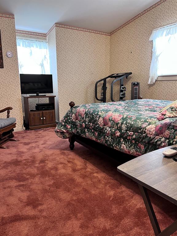 FIRST SPACIOUS BEDROOM UPSTAIRS.  THAT\'S A KING SIZE BED