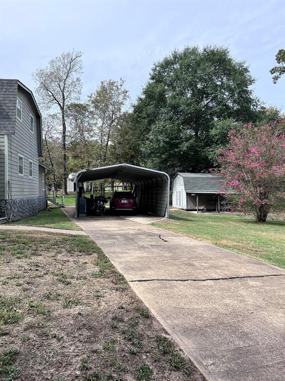 CARPORT AND STORAGE BUILDING IN RELATION TO THE HOUSE AND DRIVEWAY