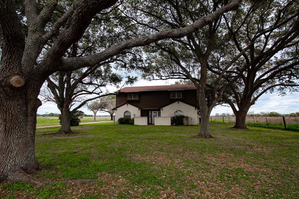 Welcome home to this stunning 1973 home full of character! Located south of Sealy, in the small community of Frydek, Texas this house is nestled underneath 50 year old live oak and pecan trees in the countryside. This four bed two and a half bath home boasts 2,129 square feet, three garage spaces, a large living room, and two separate dining areas. Although the space is plentiful, the original woodworking details only add to the charm of the home with exposed beams and arched doorways throughout the downstairs. Updates such as a new HVAC system, septic system, exterior paint, and the roof are all recently replaced. Exteriorly, the home sits on 5.78 acres with opportunities for agriculture and homesteading. Don't wait to call this beautiful slice of heaven your own, call today!