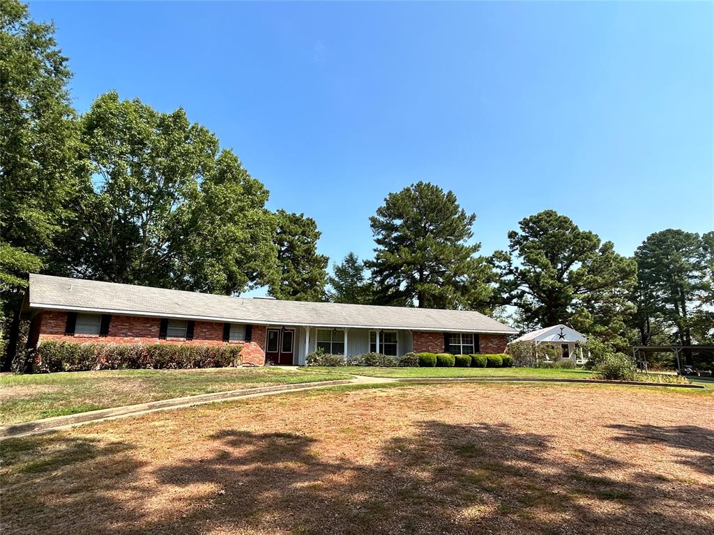 Beautiful brick home on 11.479 acres. This place is ideal with just enough acreage.  It is approximately 2 miles from Loop 304 on FM 3313 near the Nottingham Woods Subdivision. Three bedrooms, 2 and a half baths. Dining room, living room with custom made wood burning fireplace.  Kitchen, extra spacious laundry room, den area that was once used as an additional bedroom.  Screened in back porch with additional pergola for relaxing or entertaining in the back yard.   Two car garage. Outside you will find an additional building that adds so much charm to the property.  It has a porch and patio area, the building can be used for crafting, sewing, gardening or whatever you desire.

The land is a mixture of open and wooded.  Long driveway from FM 3313 that leads to the house gives lots of privacy.