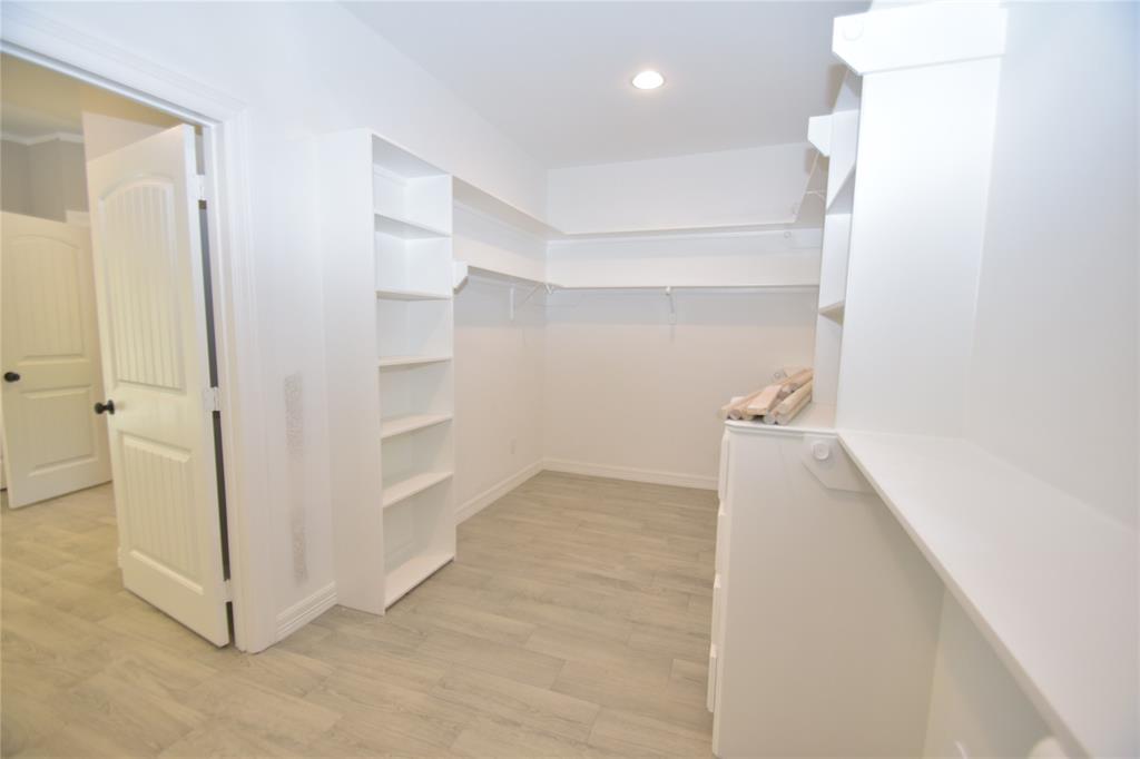 MASSIVE PRIMARY CLOSET WITH TONS OF BUILT INS