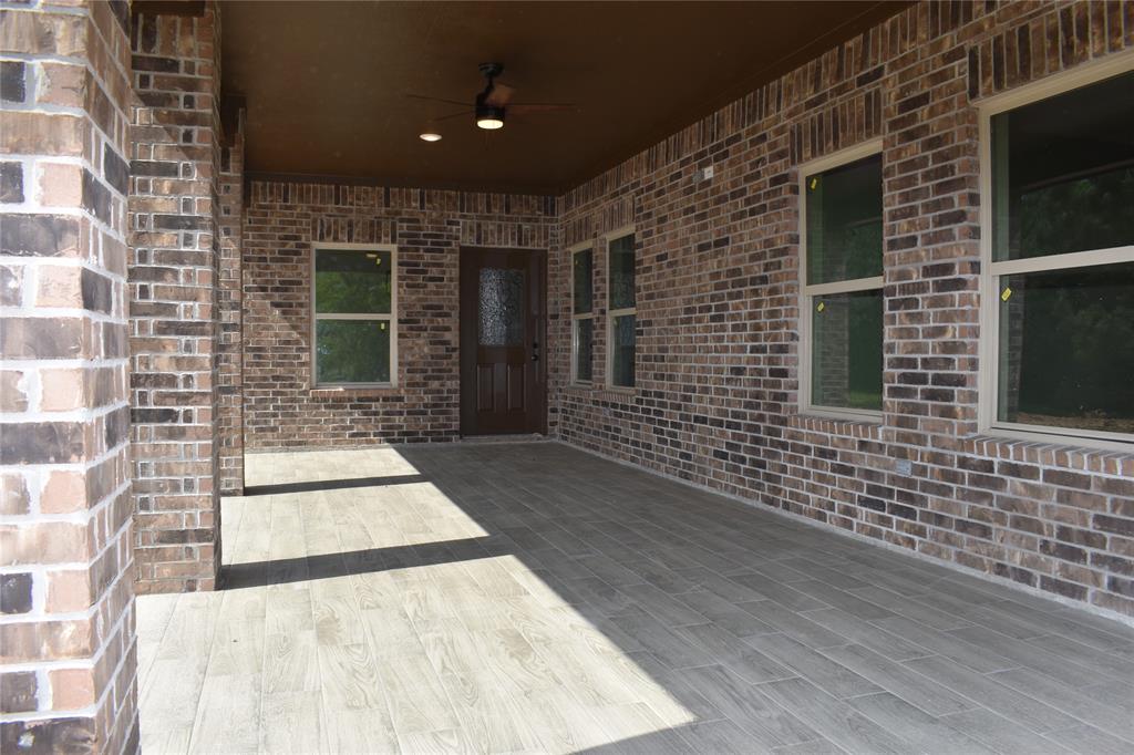 CLOSE UP OF THE BACK PORCH WITH TILED FLOORING.