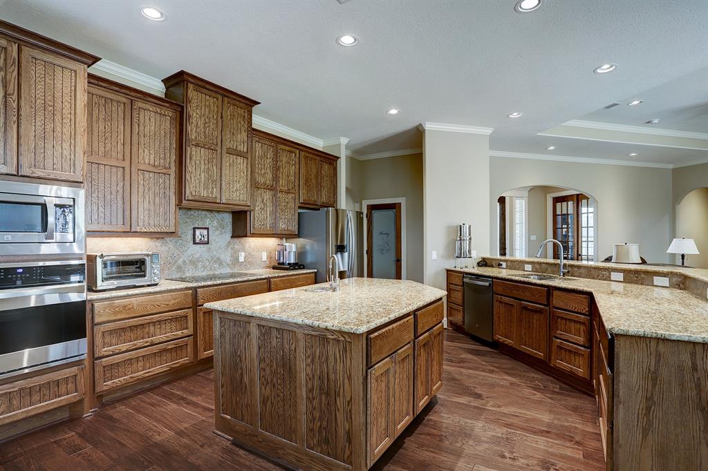 Gorgeous tall cabinets line the walls, providing plenty of storage for cookware. The kitchen seamlessly integrates with the living space, enhancing the overall flow and openness of the home.