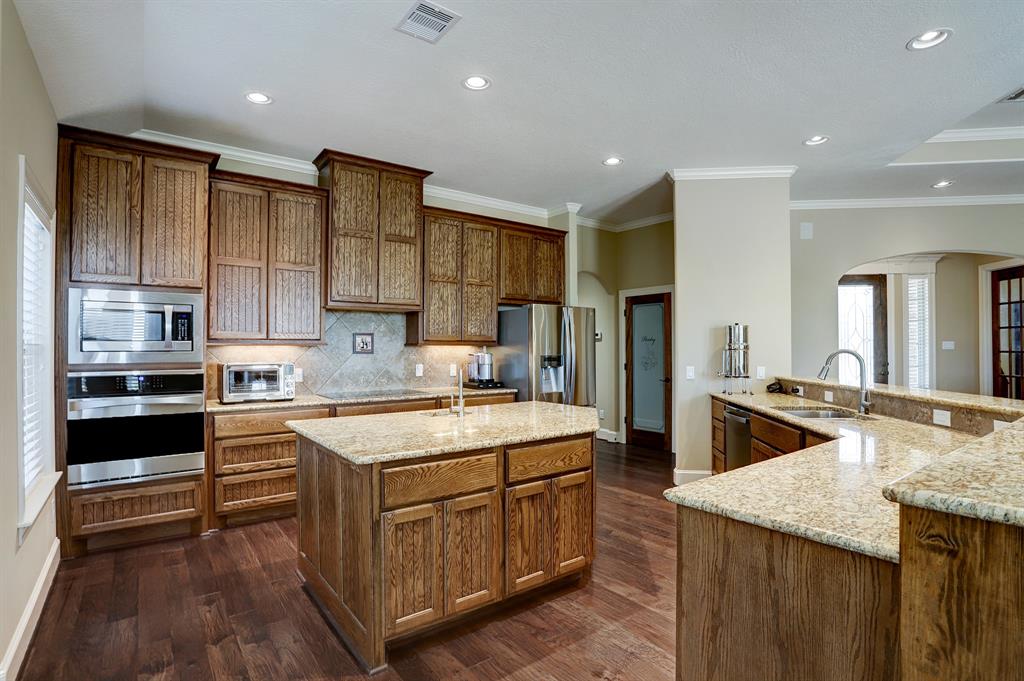 Custom kitchen featuring a spacious island complete with an extra sink integrated into its design.