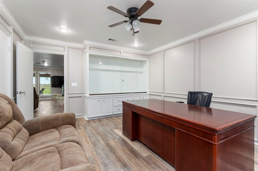 Another view of the bonus room with closet and abundant custom  built in cabinetry.