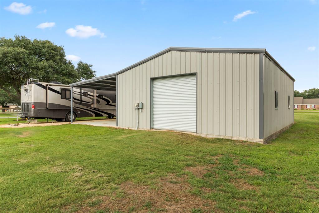 An overhead door at the rear of the shop building provides drive through convenience.