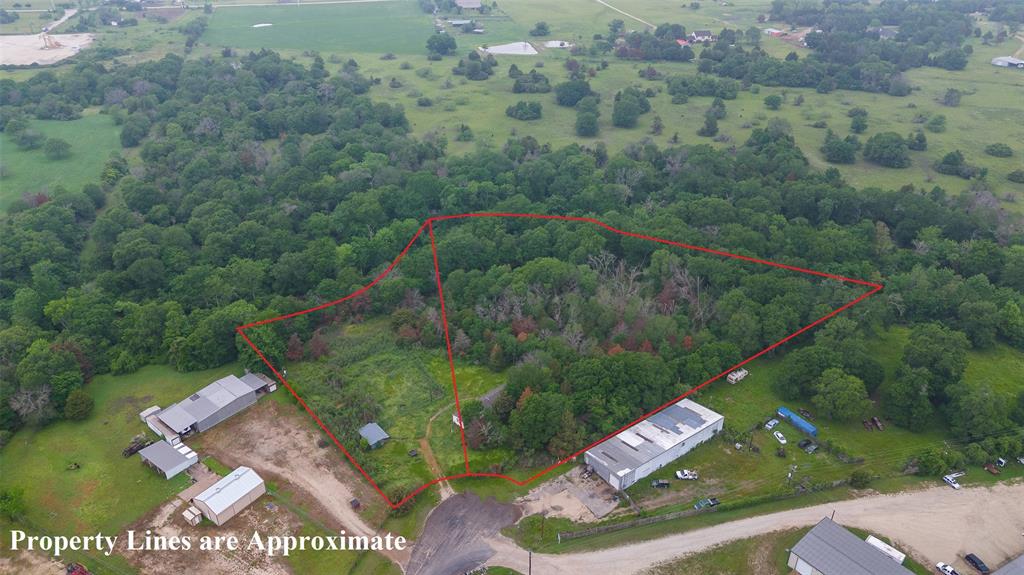 Nestled on lush acreage, this distinctive commercial property presents a rare opportunity for a versatile investment set-up purchasing these two adjacent lots totaling 6.31 acres. Zoned both for industrial and residential uses, this parcel offers two structures including a 2003 mobile home with 3 bedrooms and 2 baths with a 2.5 year-old A/C unit.The property unfolds with wide, fenced grounds surrounded by mature trees. A tranquil pond adds a touch of nature's serenity. This property propels versatile possibilities, a fantastic investment for industrial or residential use with the convenient location near HWY 21. Experience the potential for yourself today.