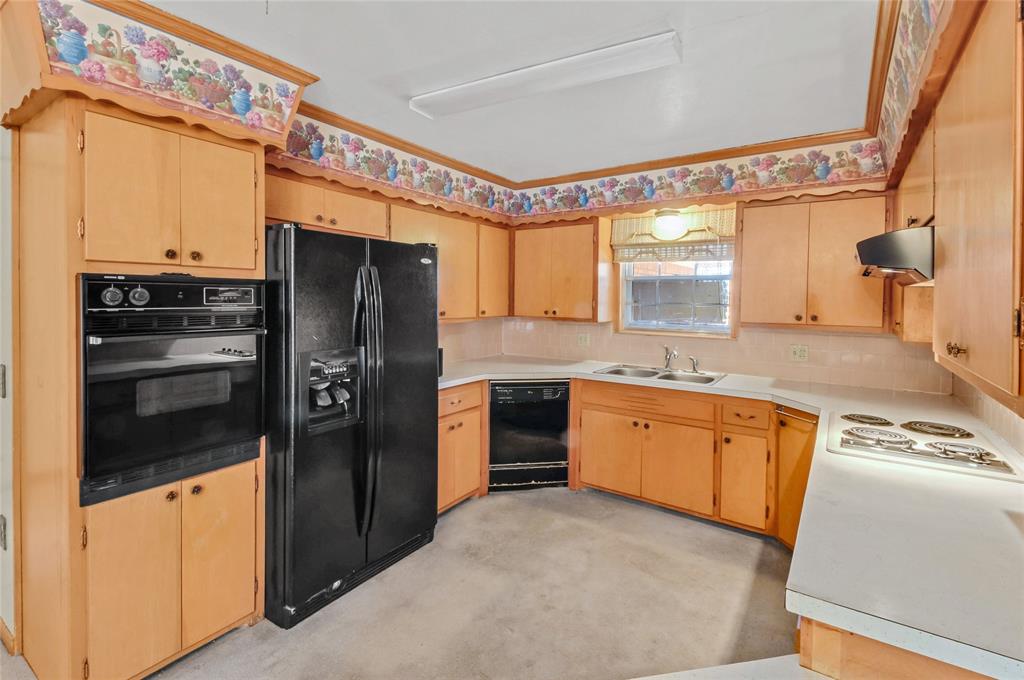 Kitchen has all electric appliances and double sink.