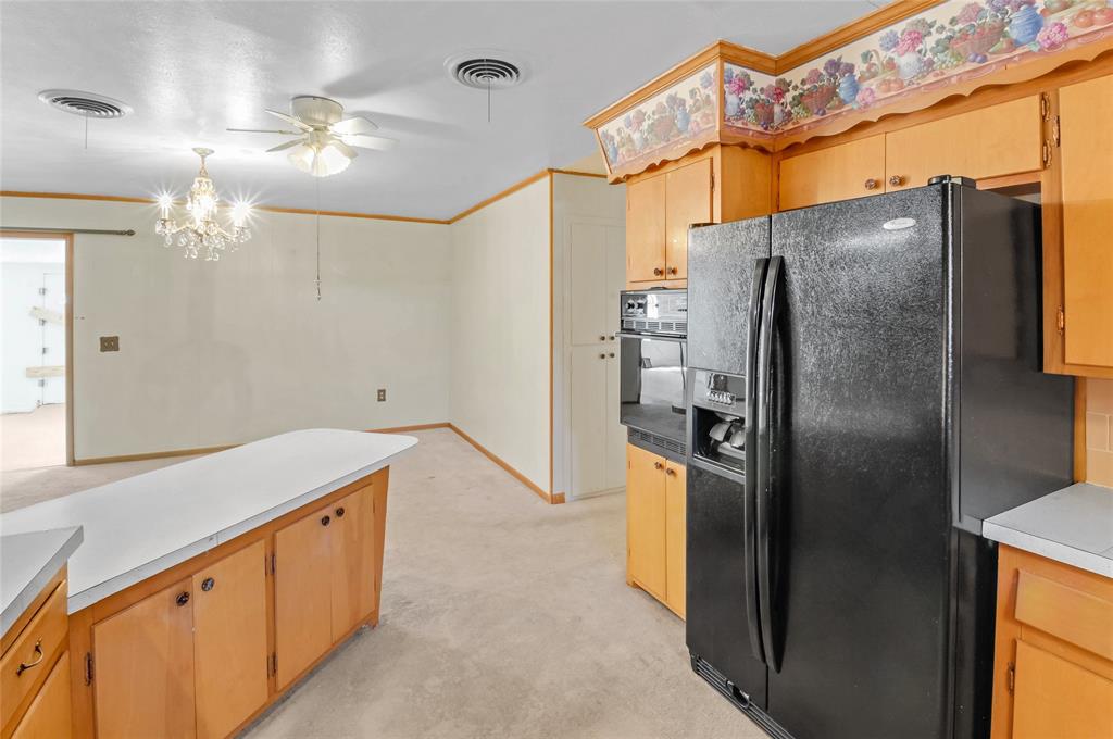 Kitchen with convenient breakfast bar leads in to dining area.