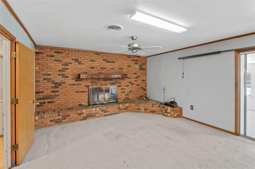 Dining area opens to this spacious den with wood burning fireplace (with gas connection if you want to add gas logs)