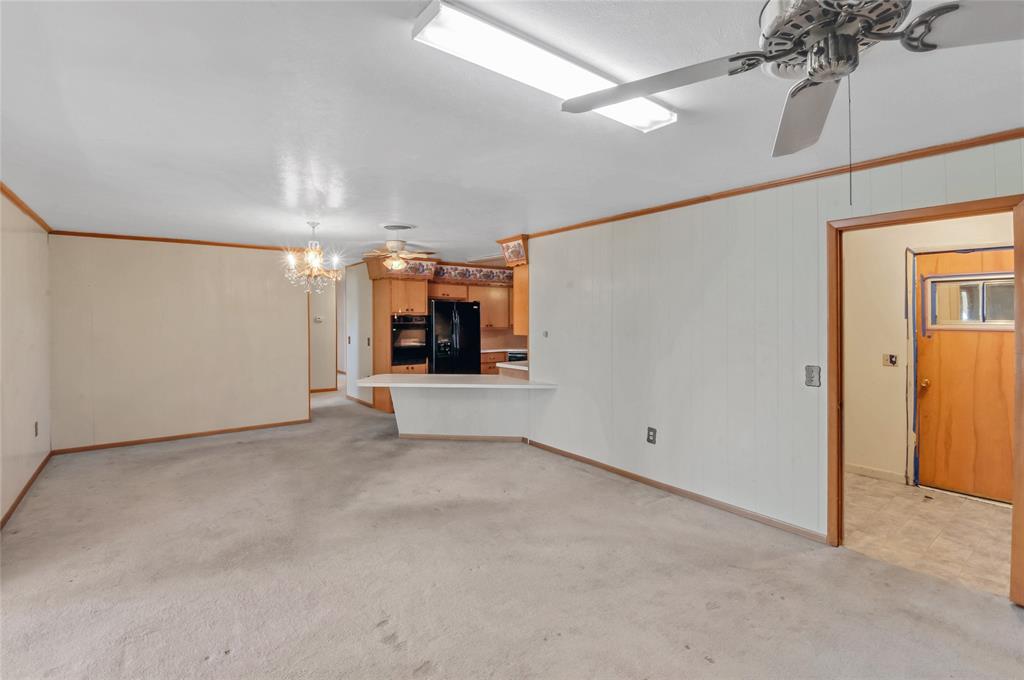 Looking from back of den toward kitchen, the seperate laundry room is off to the right.