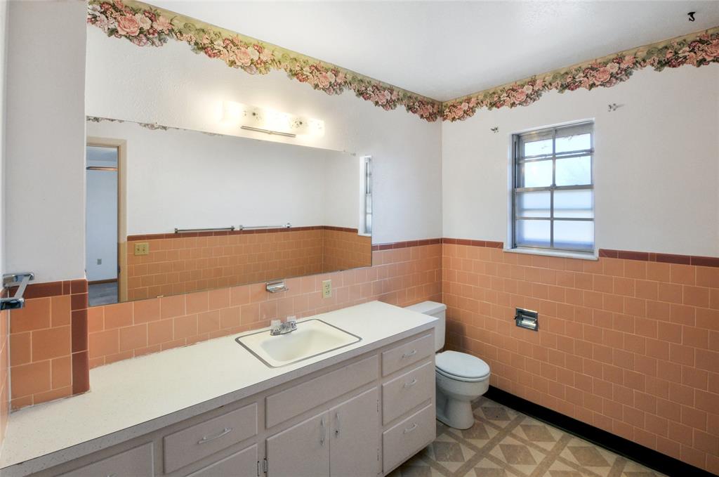 Primary En-Suite Bathroom has a wide vanity and mirror.