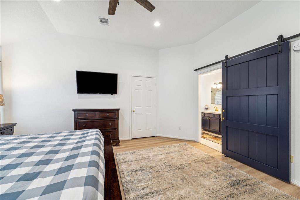 Custom barn door leading to primary bath.