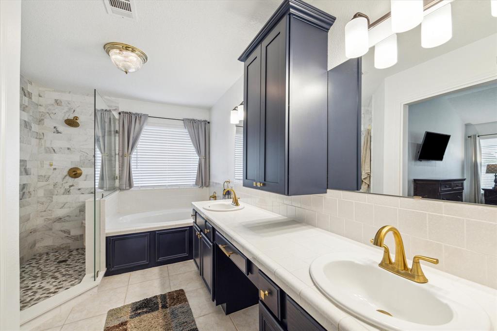 Renovated primary bath with soaking tub and large walk in shower.