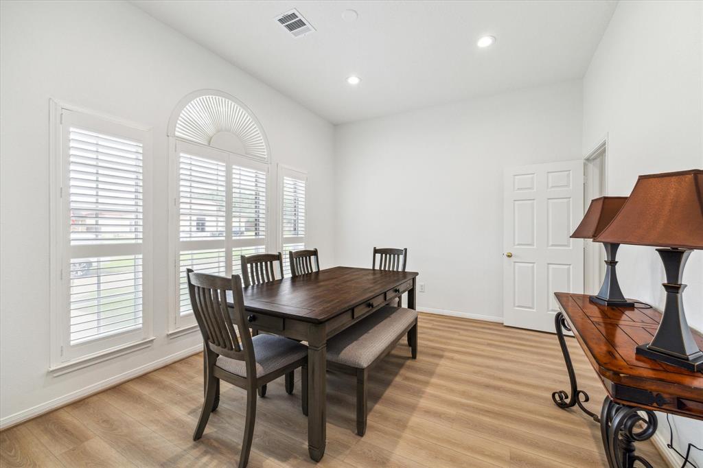 Spacious dining room off the entry with planation shutters.