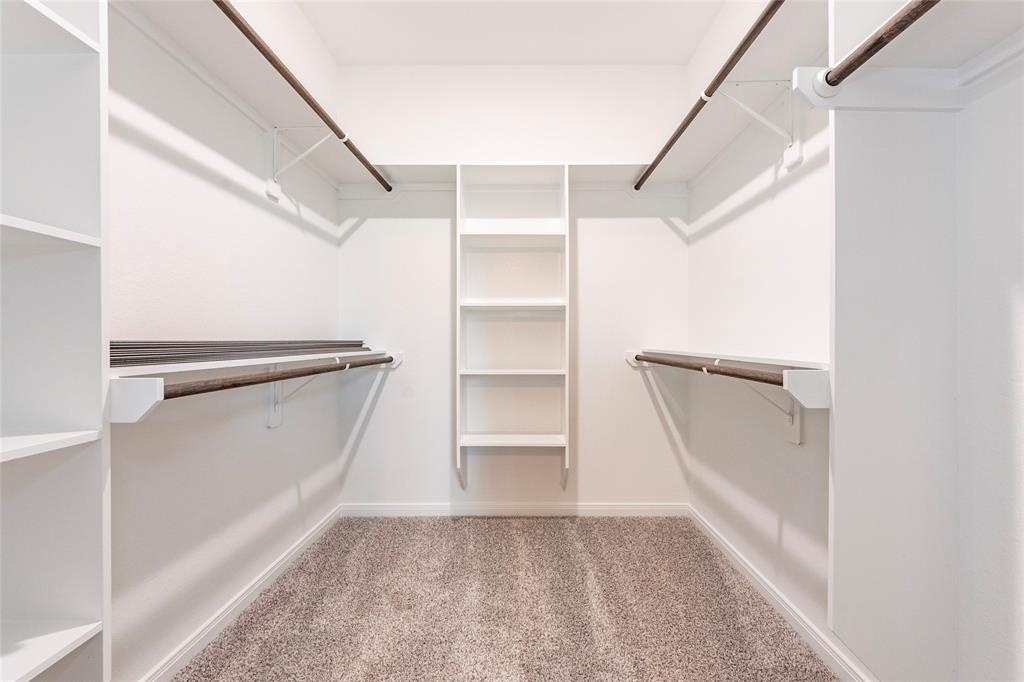 Big walk in closet with hanging shelves