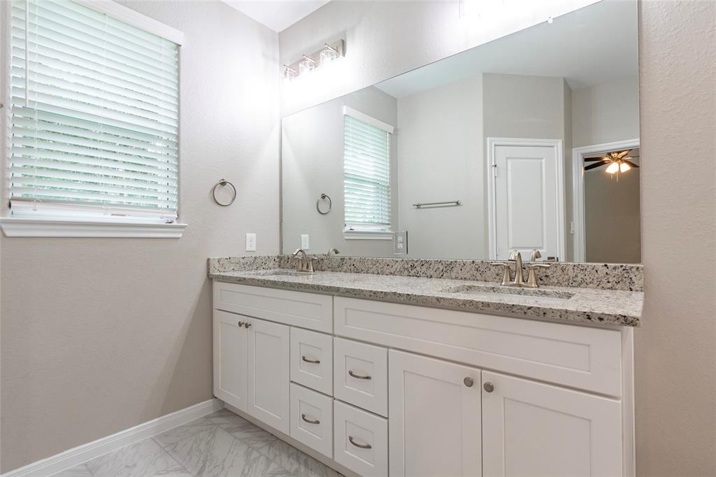 Primary bath has double sinks, lots of drawer storage and soft close cabinetry