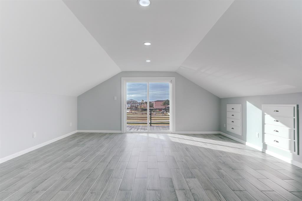 OVERSIZED PRIMARY SUITE WITH DOUBLE PANE SLIDING GLASS DOORS THAT OPEN TO THE PRIVATE BALCONY.