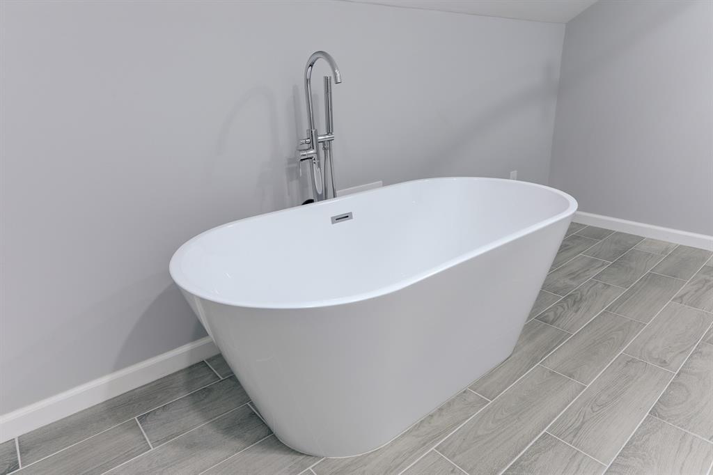 THE BATHROOM IS FINISHED WITH THE DEEP, STANDALONE SOAKING TUB.