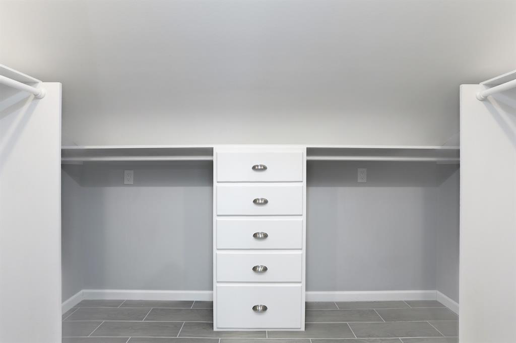 WALK-IN CLOSET WITH BUILT-INS.