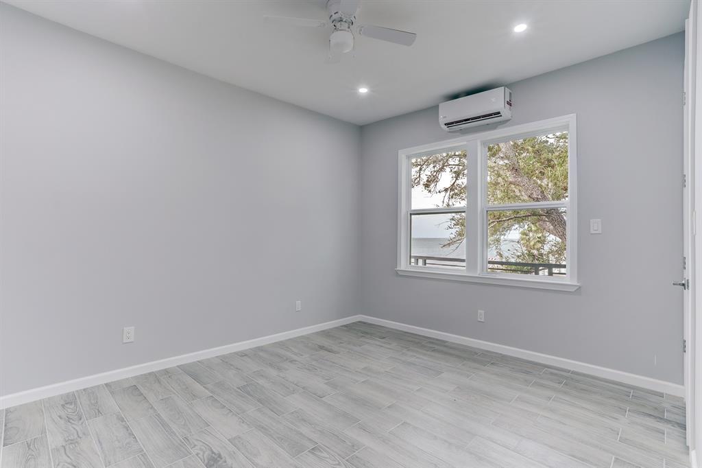 SECOND BEDROOM LOCATED ON THE FIRST LEVEL WITH WALK-IN CLOSET AND WATER VIEWS.