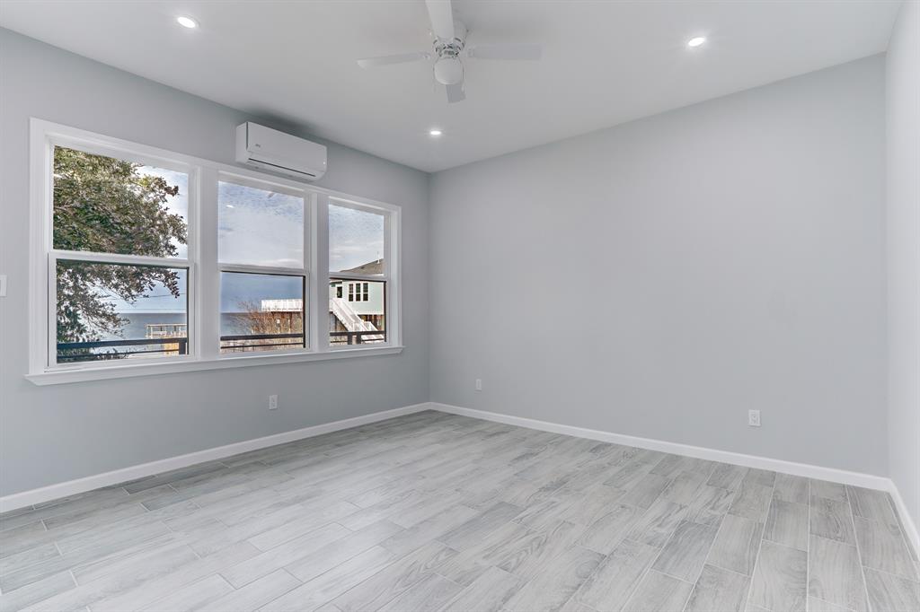 THIRD BEDROOM LOCATED ON THE FIRST LEVEL WITH WALK-IN CLOSET AND WATER VIEWS.